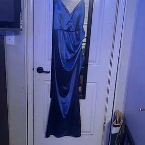 silk dress that is tight fitting w/ high slit.Pretty blue and a lot of stretch!